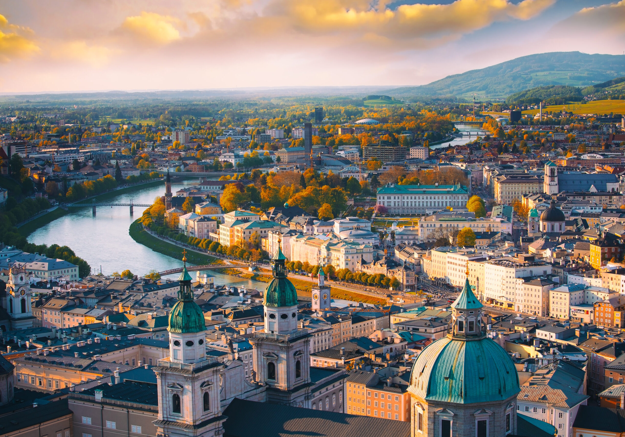 Beautiful of Aerial panoramic view in a Autumn season at a historic city of Salzburg with Salzach river in beautiful golden evening light sky and colorful of autumn at sunset, Salzburger Land, Austria